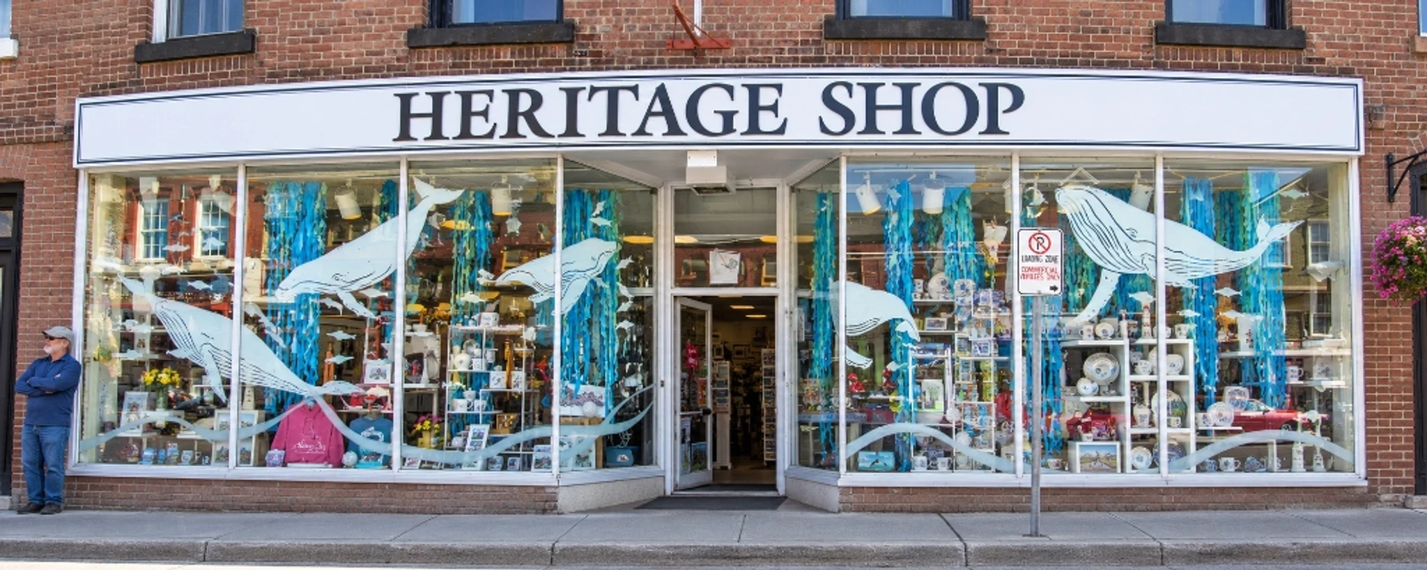 Heritage Shop storefront with whale-themed window displays and a central entrance.